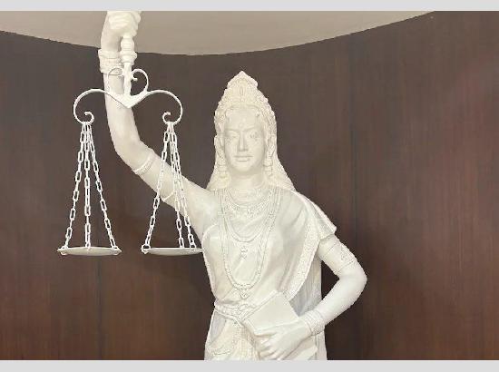 'Law is not blind':  Lady Justice in Supreme Court library now holds a Constitution with open eyes   