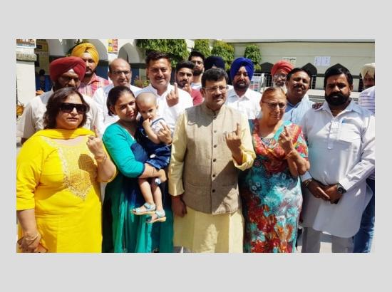 BJP leader Kamal Sharma, family members cast their vote for LS polls 2019